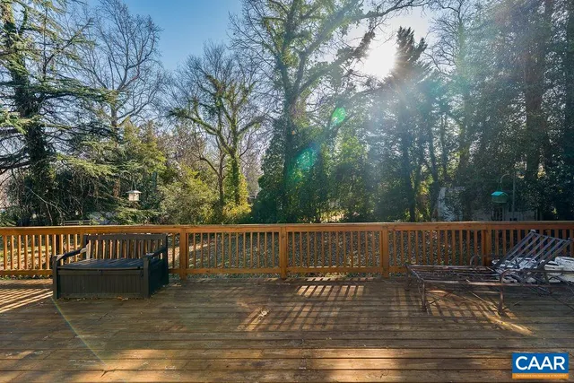 a balcony with wooden fence and bench