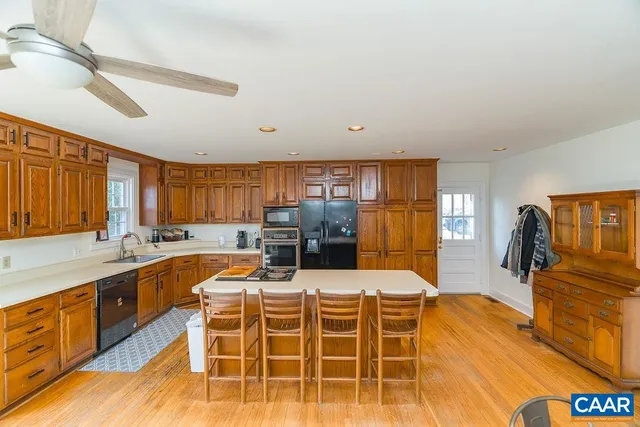 a large kitchen with a sink and cabinets
