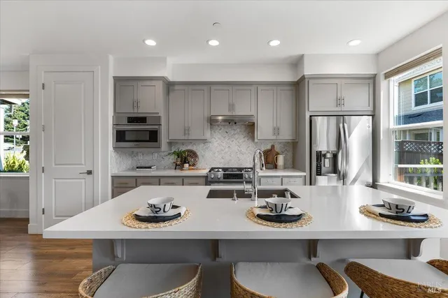 a kitchen with a sink a counter top space and appliances