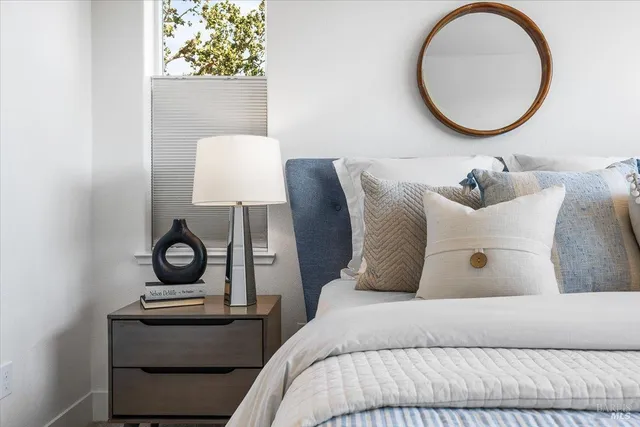 a bedroom with a bed and a chandelier
