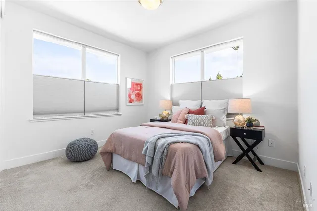 a bed sitting in a bedroom next to a window