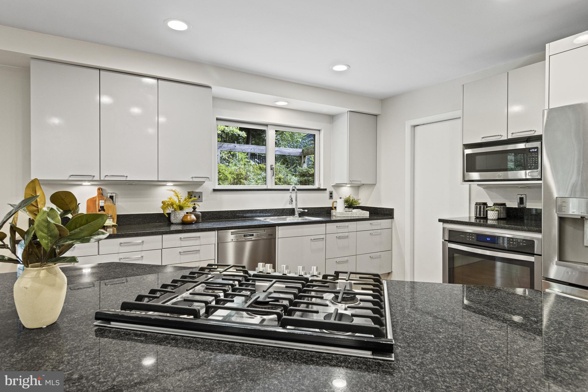 7107 Roxann Road Alexandria, VA 22315 - Photo 11 of 62 a kitchen with wooden cabinets and a stove top oven