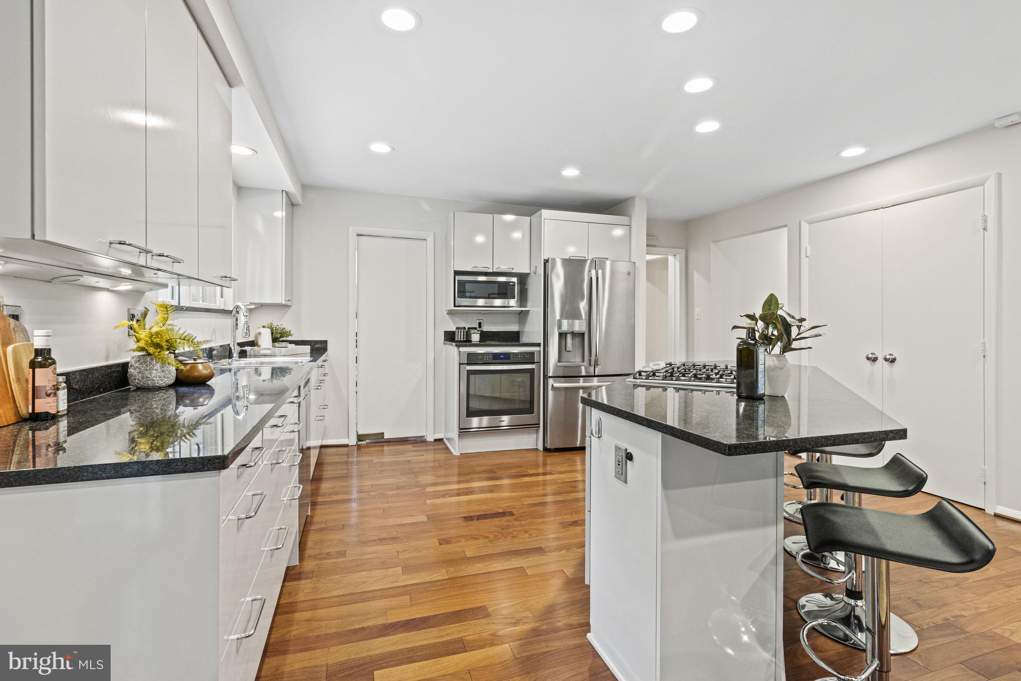 7107 Roxann Road Alexandria, VA 22315 - Photo 13 of 62 a kitchen with kitchen island a counter top space appliances and cabinets