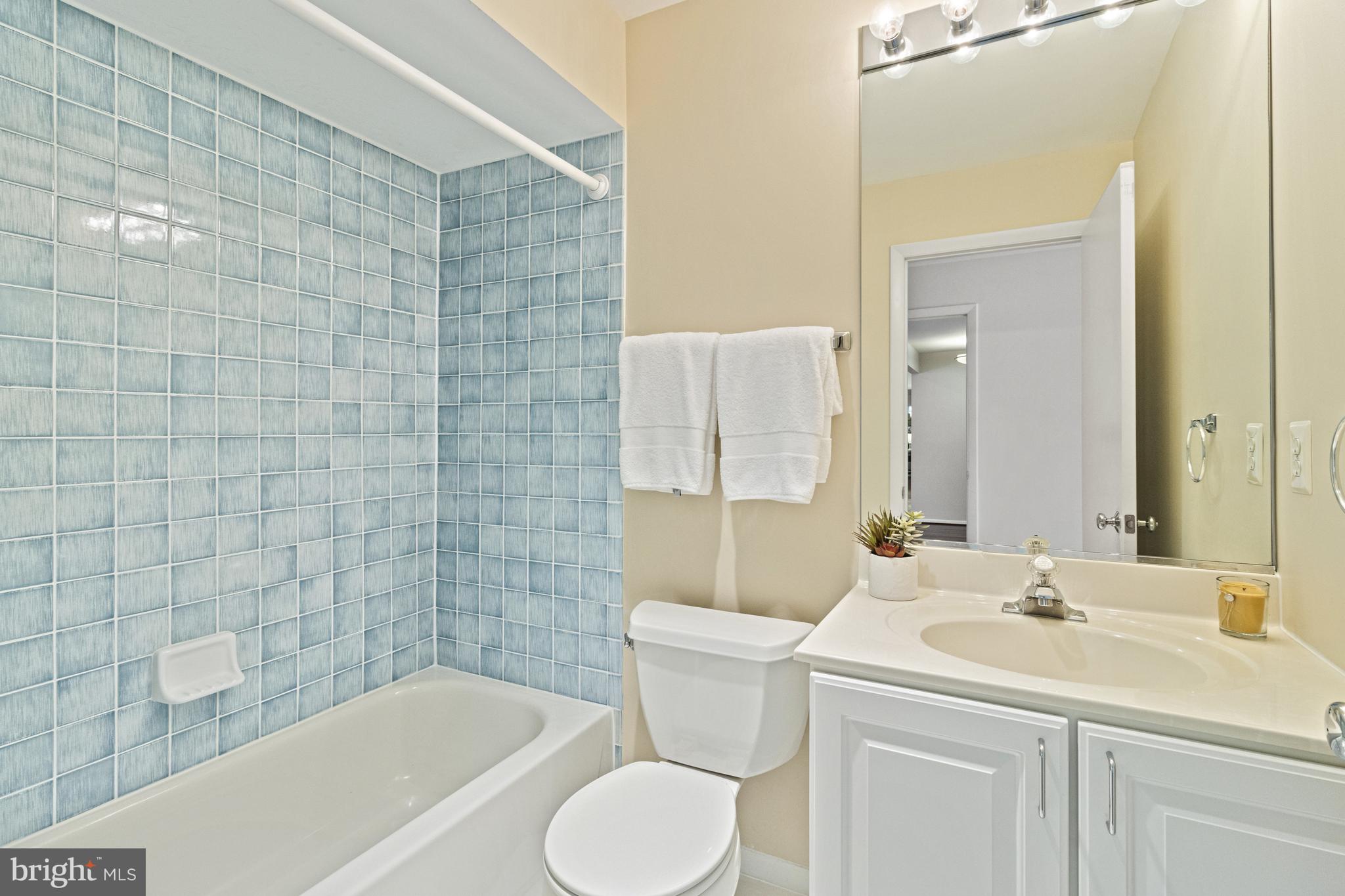 7107 Roxann Road Alexandria, VA 22315 - Photo 21 of 62 a bathroom with a sink toilet and shower