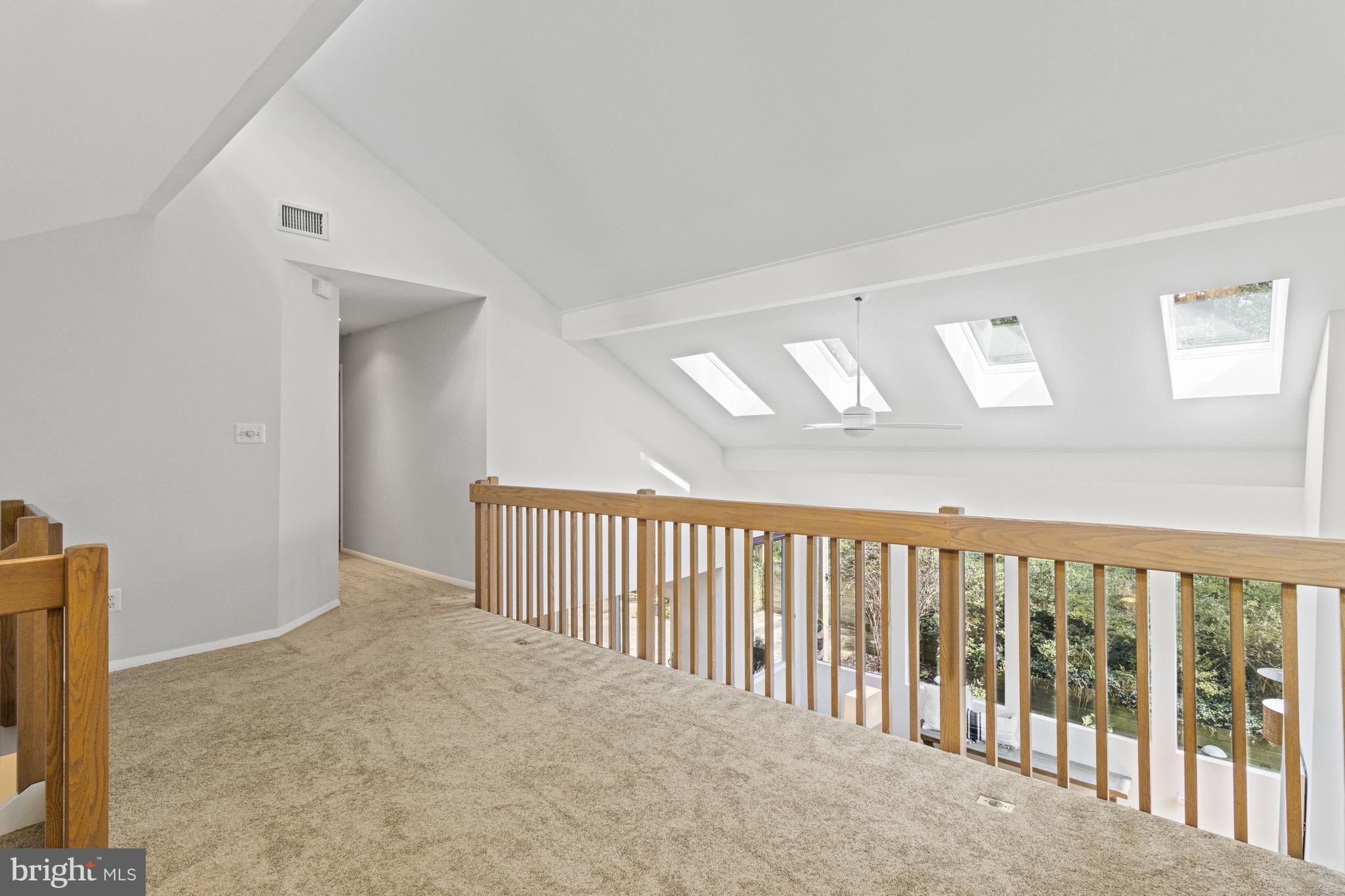 7107 Roxann Road Alexandria, VA 22315 - Photo 24 of 62 a view of a hallway with wooden floor and windows