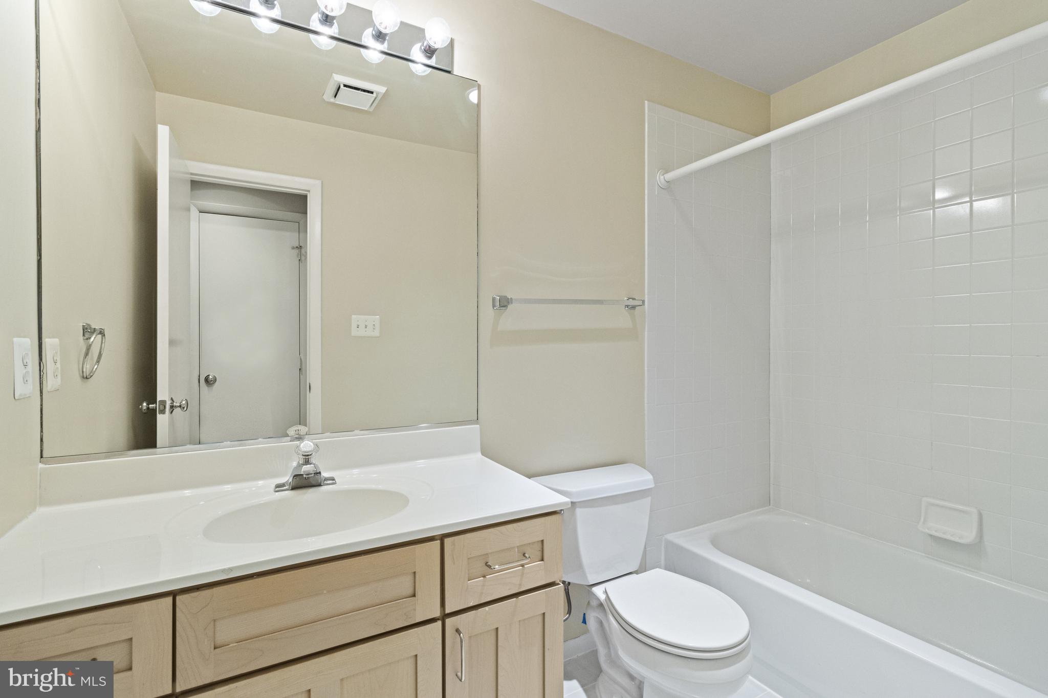 7107 Roxann Road Alexandria, VA 22315 - Photo 34 of 62 a bathroom with a sink a toilet and shower