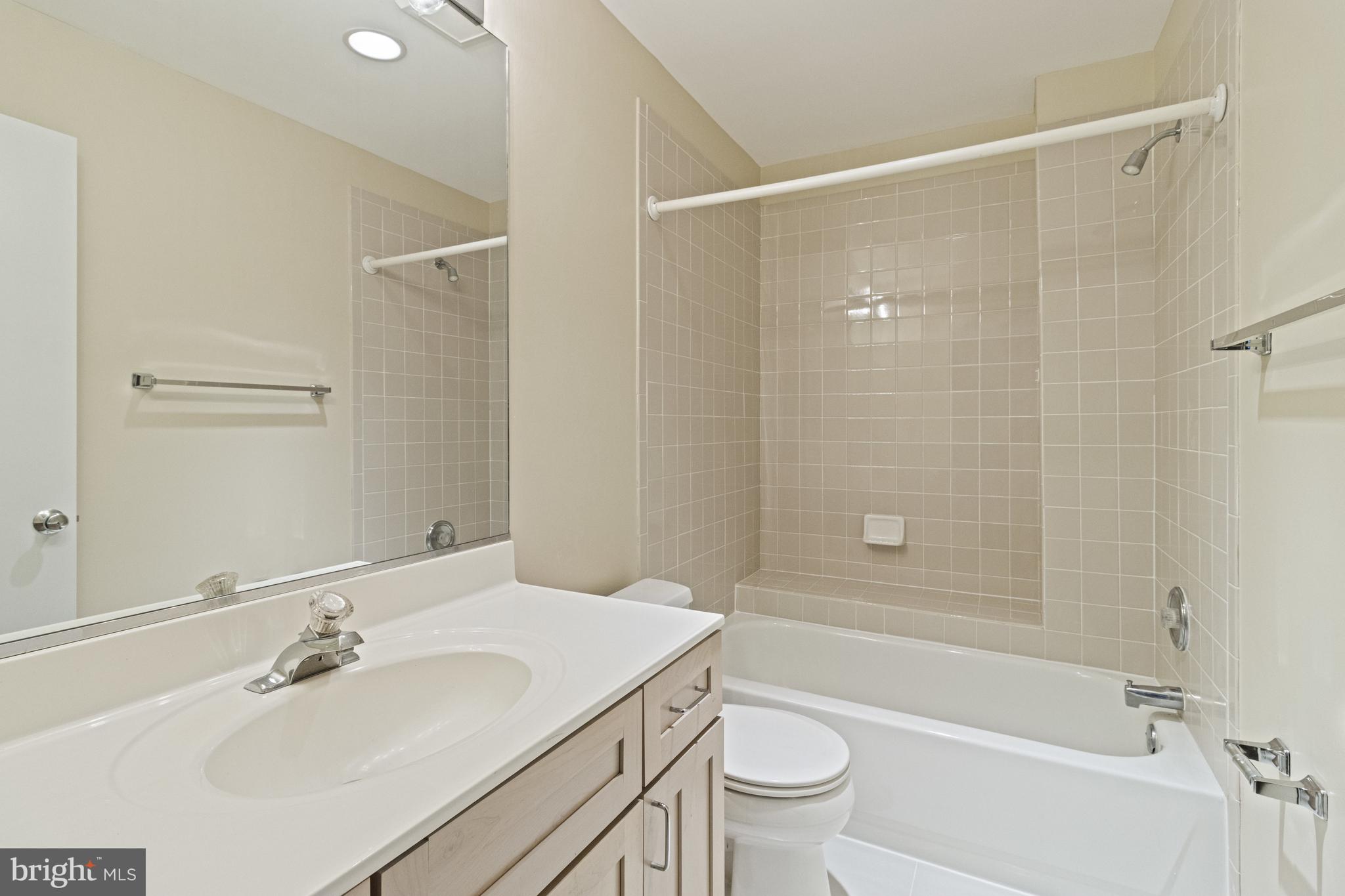 7107 Roxann Road Alexandria, VA 22315 - Photo 37 of 62 a bathroom with a sink mirror toilet and bathtub