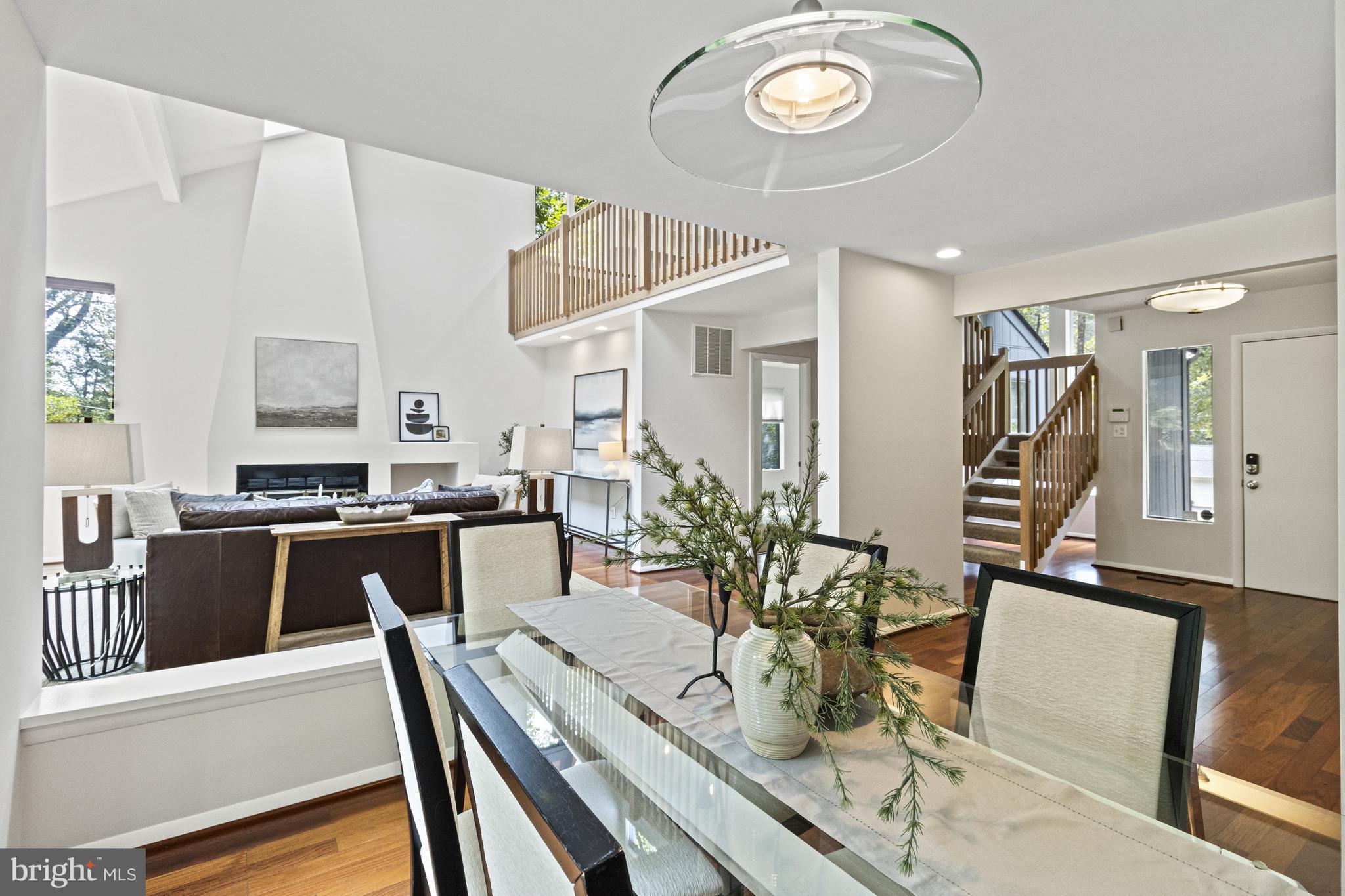 7107 Roxann Road Alexandria, VA 22315 - Photo 8 of 62 a view of a dining room and livingroom with furniture wooden floor and a rug
