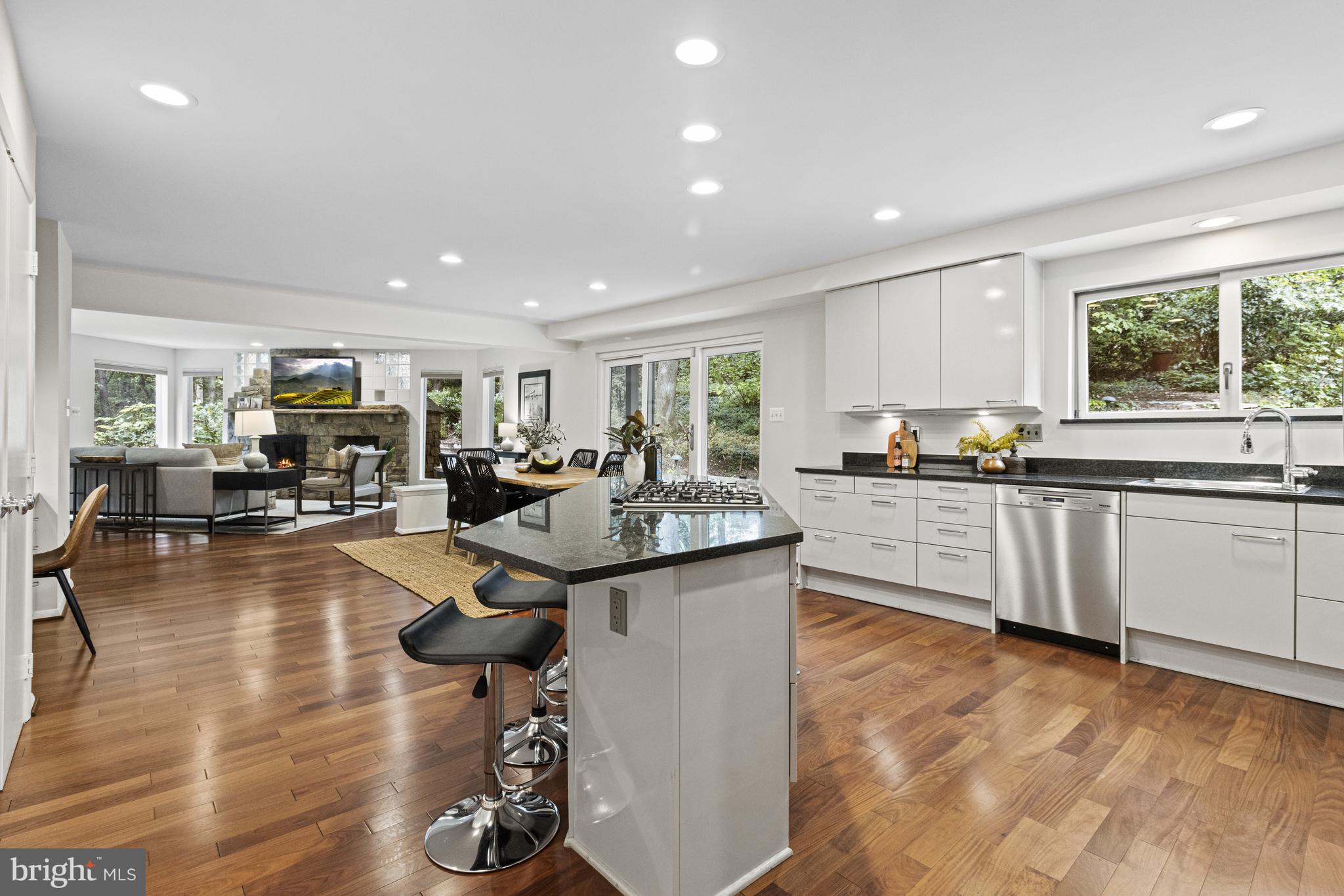 7107 Roxann Road Alexandria, VA 22315 - Photo 10 of 62 a kitchen with stainless steel appliances granite countertop a refrigerator a stove a sink dishwasher and white cabinets with wooden floor