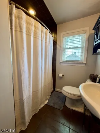 a white toilet sitting next to a bathroom sink