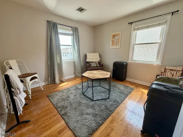 a living room with furniture rug and a window