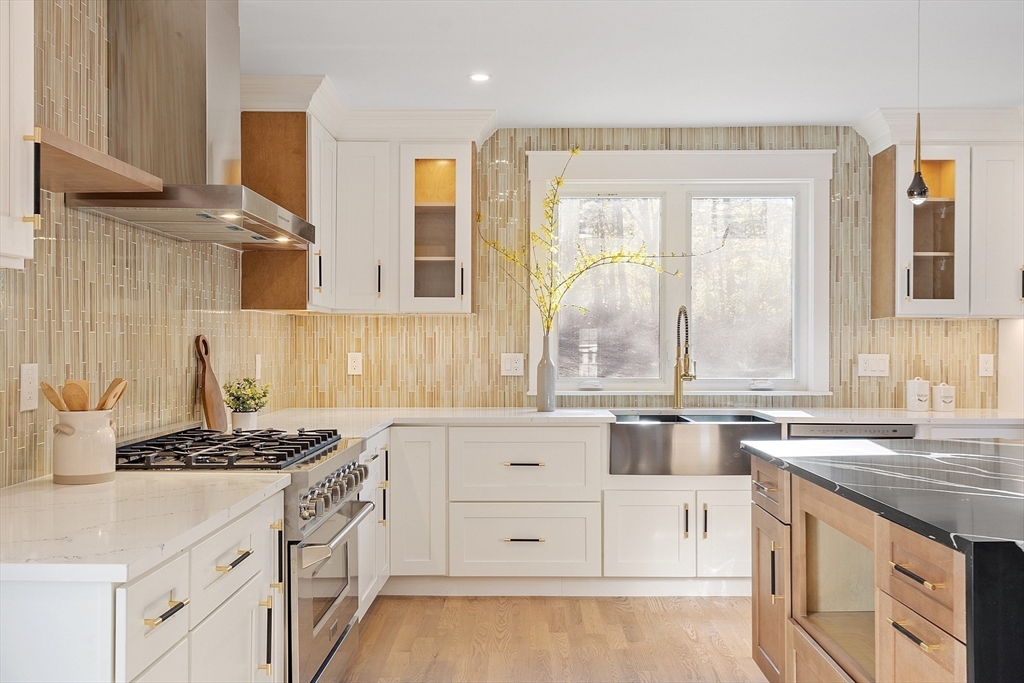 896 Main Street Reading, MA 01867 - Photo 22 of 41 a kitchen with granite countertop a sink stove and cabinets