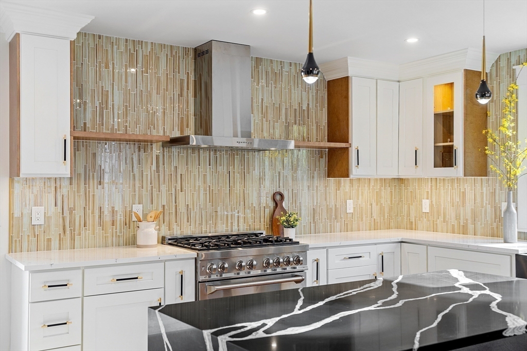 896 Main Street Reading, MA 01867 - Photo 24 of 41 a kitchen with granite countertop a sink stainless steel appliances and cabinets