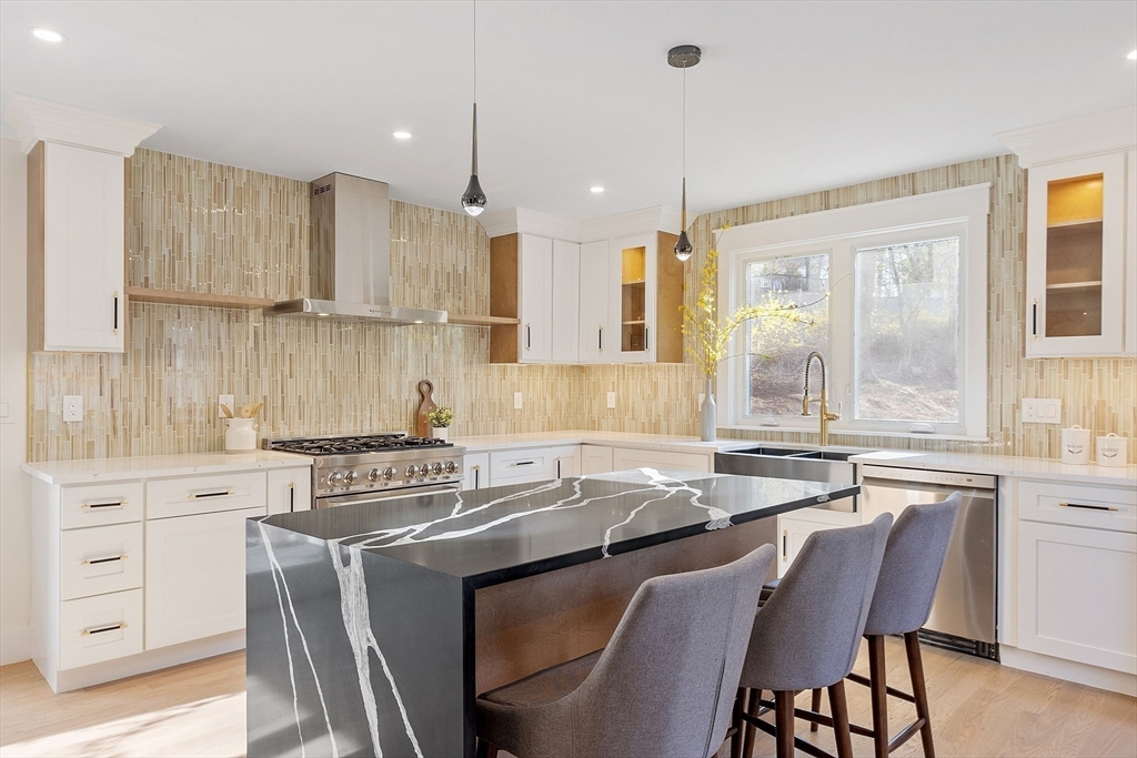 896 Main Street Reading, MA 01867 - Photo 25 of 41 a kitchen with stainless steel appliances granite countertop a table chairs sink and cabinets