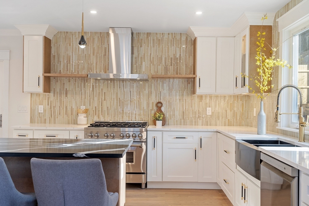 896 Main Street Reading, MA 01867 - Photo 26 of 41 a kitchen with stainless steel appliances granite countertop a stove a sink and a white cabinets