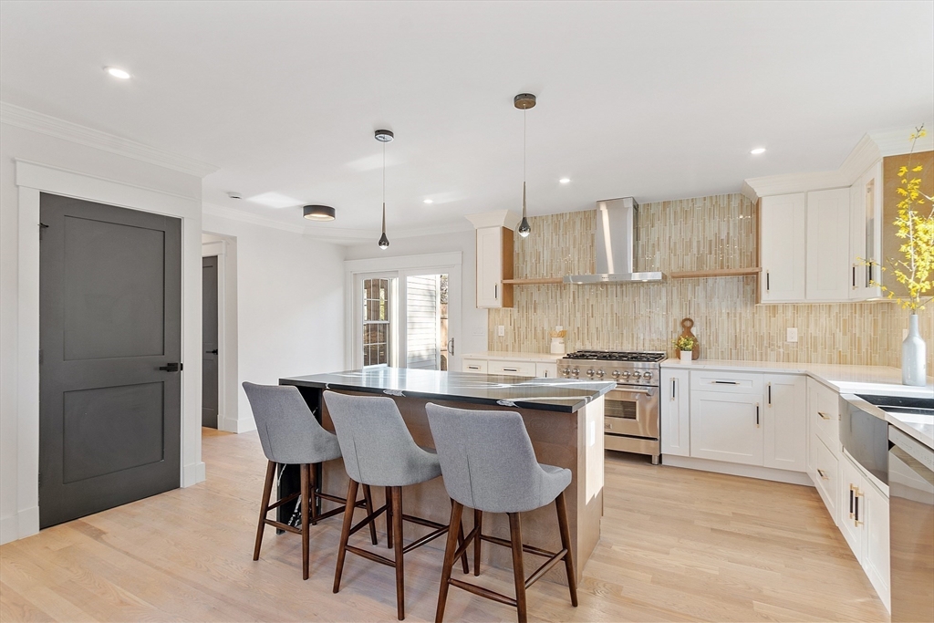 896 Main Street Reading, MA 01867 - Photo 27 of 41 a kitchen with a dining table chairs stainless steel appliances and cabinets