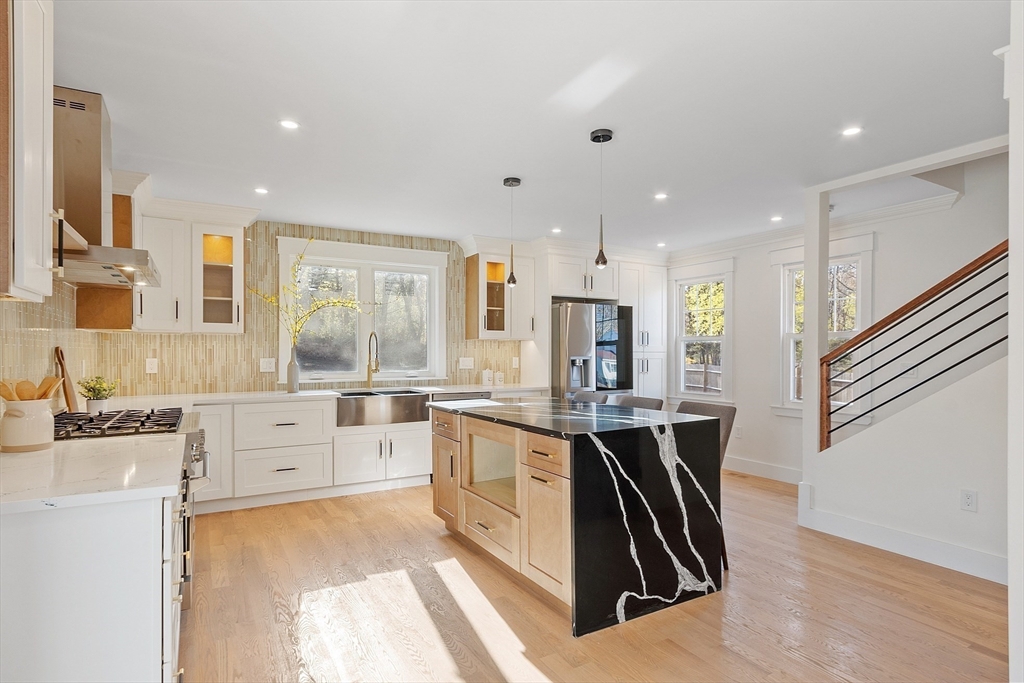 896 Main Street Reading, MA 01867 - Photo 28 of 41 a large kitchen with stainless steel appliances lots of counter space and windows