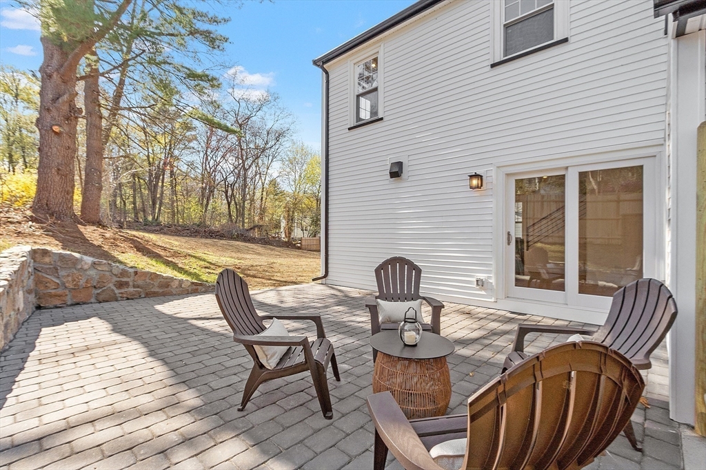 896 Main Street Reading, MA 01867 - Photo 38 of 41 a view of a patio with table and chairs and wooden fence