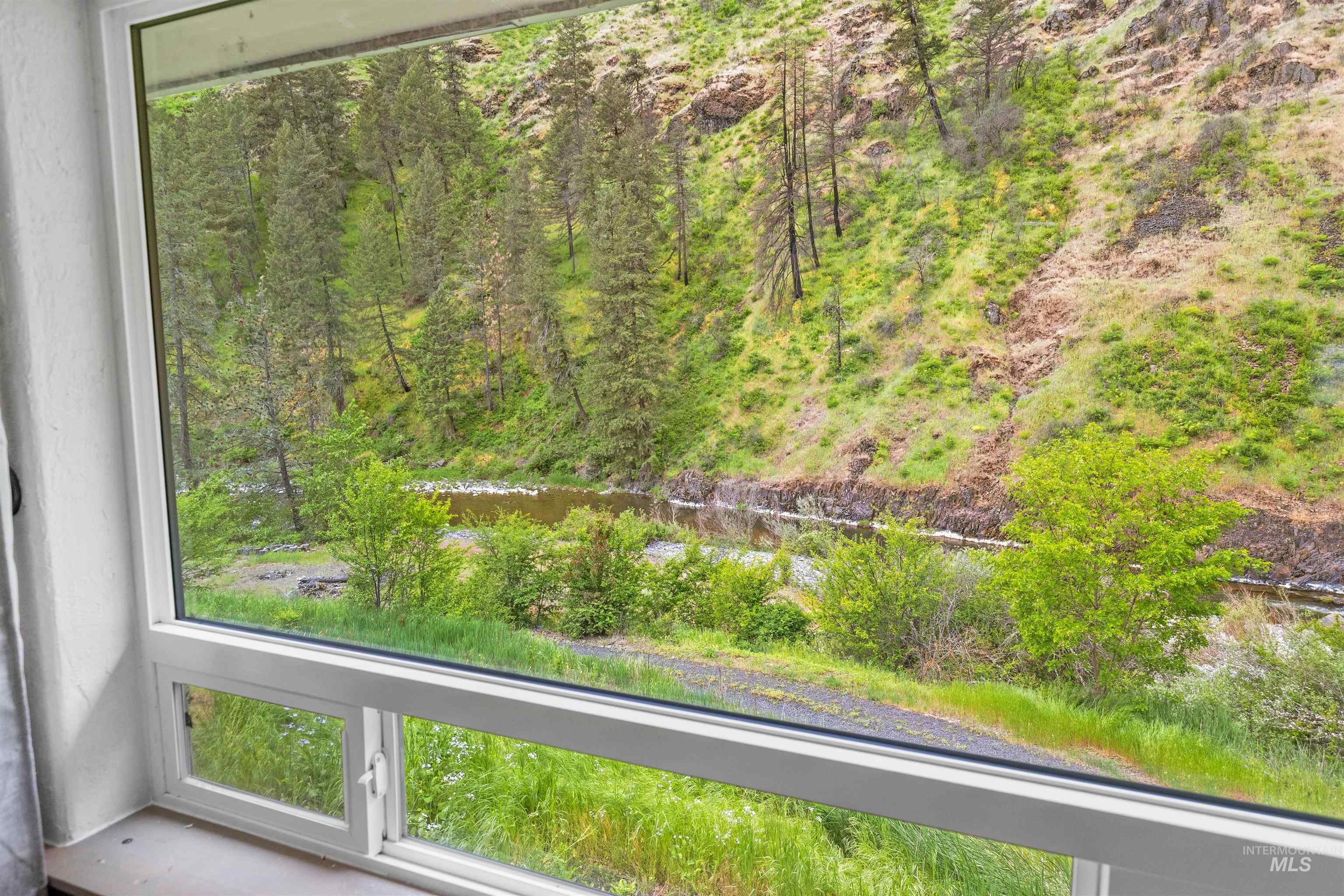 1314 Cedar Ridge Road Kendrick, ID 83537 - Photo 24 of 50 Expansive picture window framing a natural landscape with a river