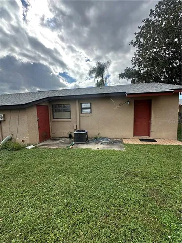a backyard of a house with table and chairs