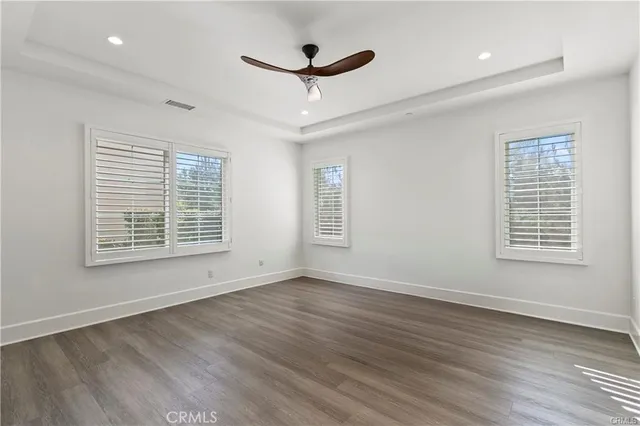 a view of a livingroom with a ceiling fan and wooden floor