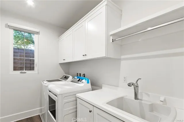 a kitchen with a sink cabinets and window