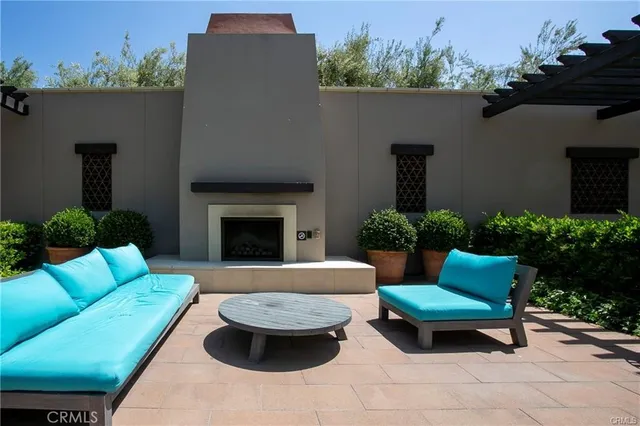 a patio with couch and a potted plant