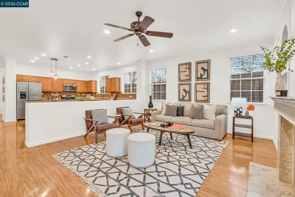 a living room with furniture a fireplace and a table