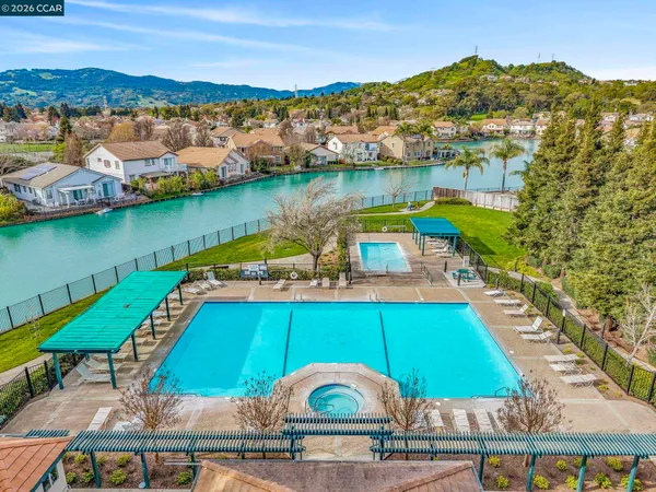 a front view of a house with a garden and trees