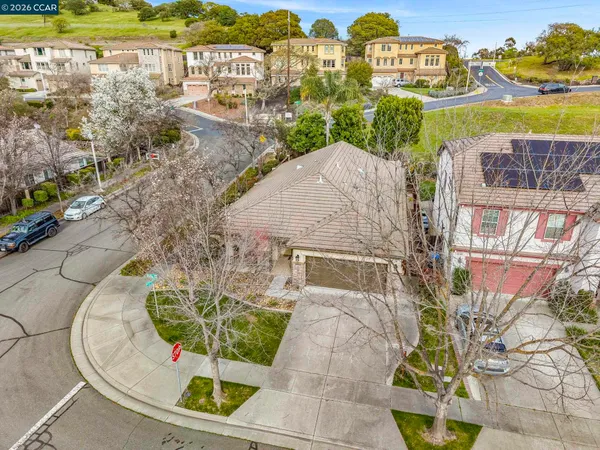 an aerial view of residential houses with outdoor space and street view