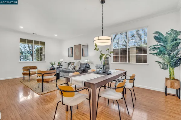 a living room with furniture and painting on the wall