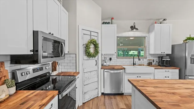 a kitchen with stainless steel appliances a stove sink and cabinets