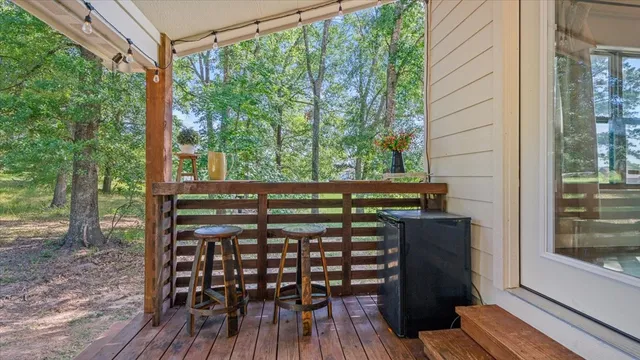 a view of a patio with table and chairs and wooden fence