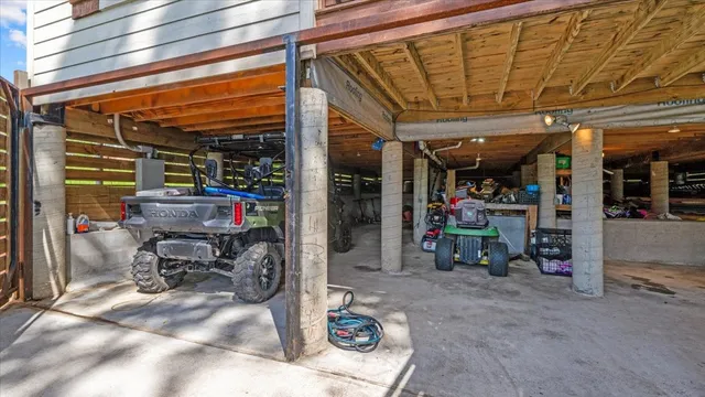 an aerial view of residential houses with outdoor space and trees