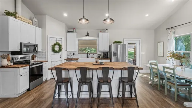 a large kitchen with a table and chairs