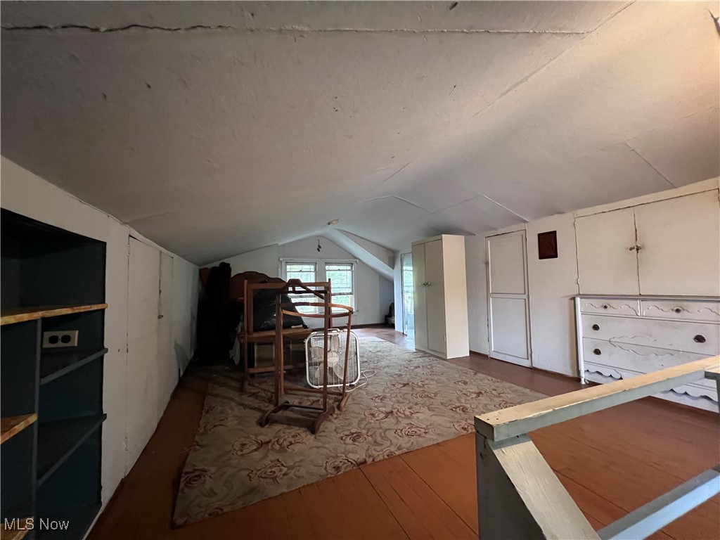 4581 Pearl Road Cleveland, OH 44109 - Photo 26 of 36 Additional living space featuring hardwood / wood-style flooring and vaulted ceiling