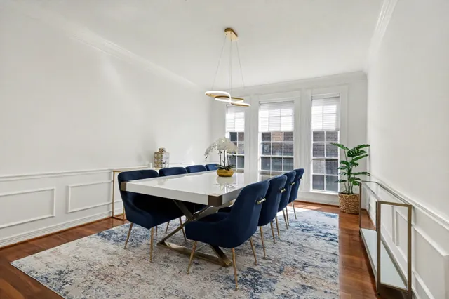 a kitchen with stainless steel appliances granite countertop a refrigerator a stove a sink and white cabinets