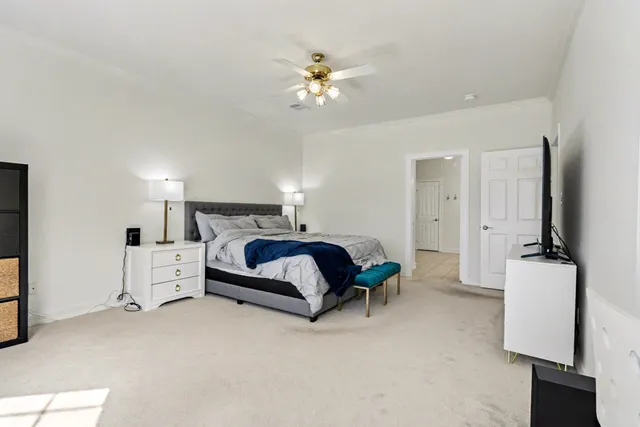 a bathroom with a granite countertop double vanity and a mirror