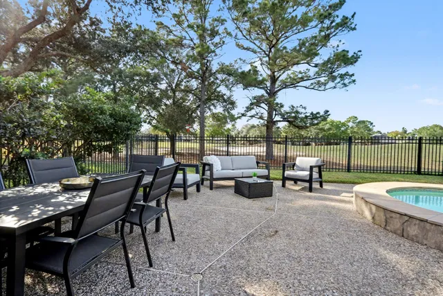 a view of a backyard with swimming pool