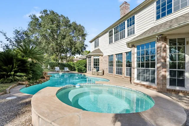a view of a house with backyard porch and sitting area