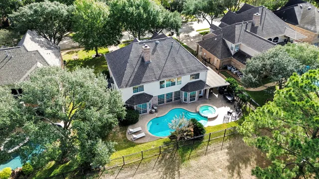 an aerial view of residential houses with outdoor space