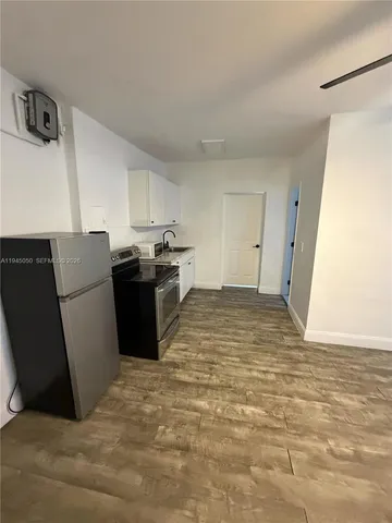 a kitchen with stainless steel appliances a refrigerator and a stove