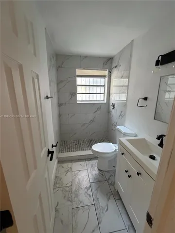 a bathroom with a toilet a sink and a bathtub