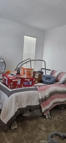 a bedroom with bed and window