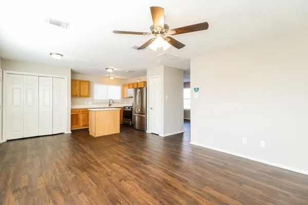 a kitchen with stainless steel appliances granite countertop a refrigerator and a stove top oven
