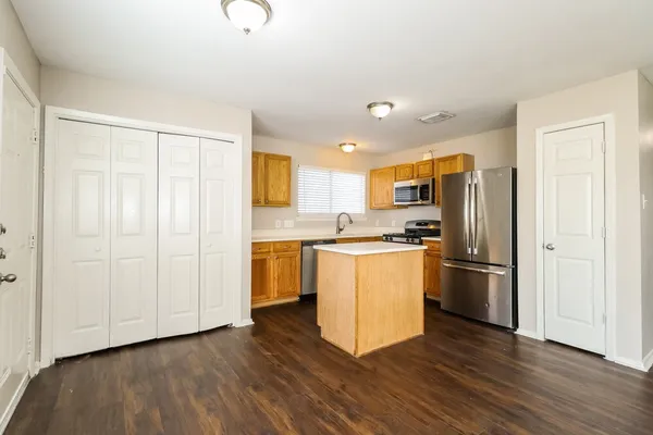 a kitchen with stainless steel appliances granite countertop a sink stove and refrigerator