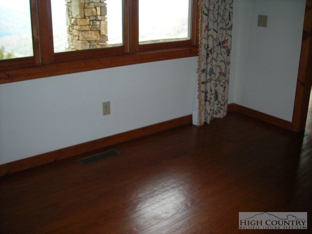 787 Fox Meadow Road Banner Elk, NC 28604 - Photo 5 of 11 a view of empty room with wooden floor and fan