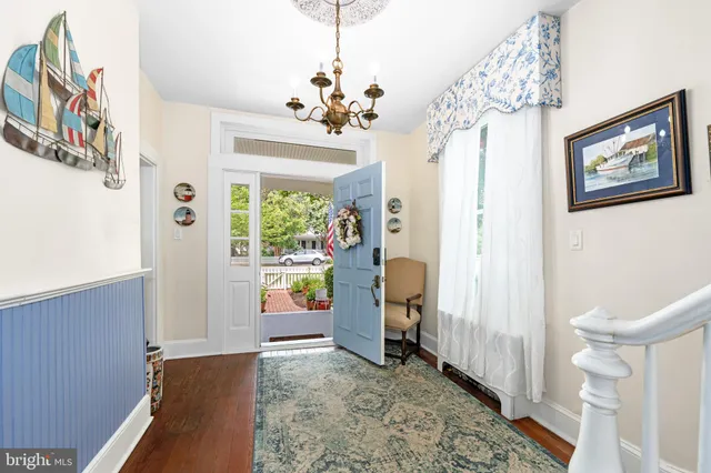 a dining room with furniture a chandelier and a rug