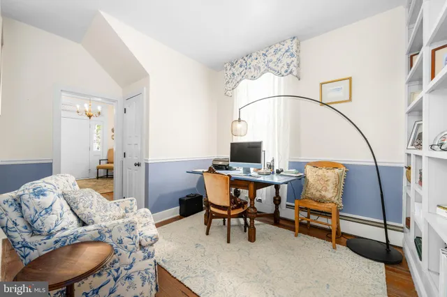 a large kitchen with kitchen island a stove a sink a oven and a dining table with wooden cabinets