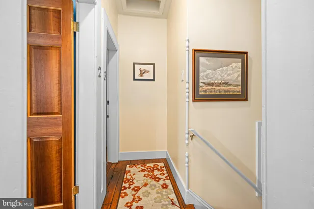 a bedroom with bed and wooden floor